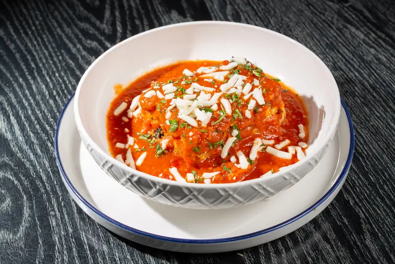 Vegetarian lasagna topped with mozzarella and tomato sauce