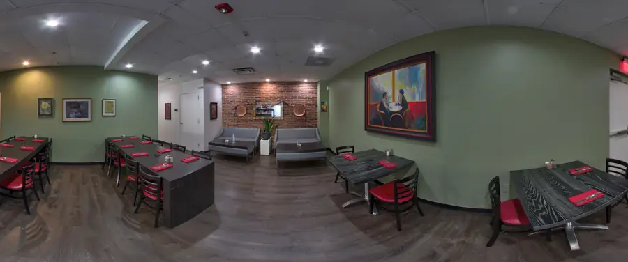 Inside Sage Vegetarian Restaurant: the order counter, plant-lined dividers and dining room